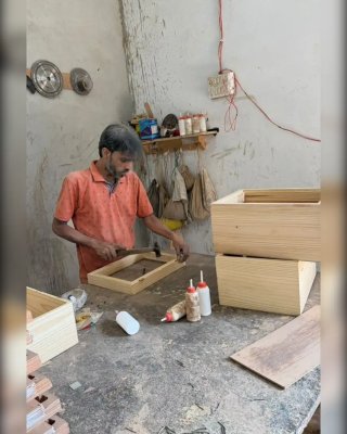 Worker Cutting Wood for Toy Manufacturing