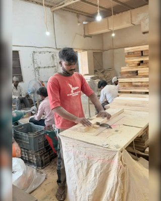 Worker Working on Wooden Toy Production